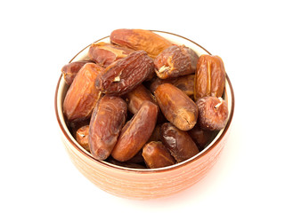 dried dates in a bowl on a white background