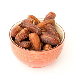 dried dates in a bowl on a white background