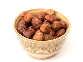 hazelnuts in a bowl on a white background