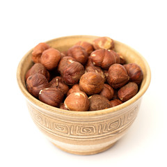 hazelnuts in a bowl on a white background
