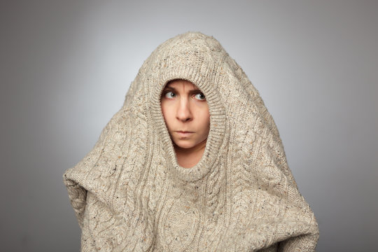 girl without a make-up hides in the huge sweater 