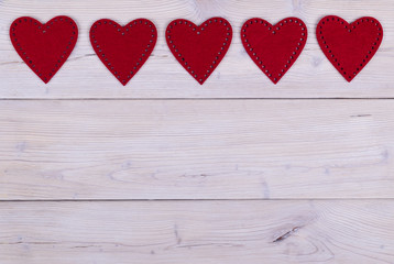 red hearts on the white rustic wooden background with woodgrain texture