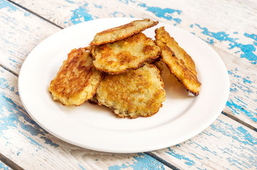 Plate with potato pancakes on the table.