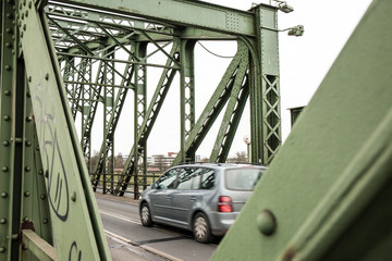 car crossing old rusty iron bridge ready for demolition