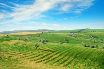 Fototapeta na wymiar Hilly terrain with a terrace and a blue sky