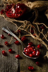 pomegranate seeds in a spoon on the table