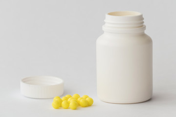 Medicine pills / Little plastic bottle with medicine pills on white background, close-up