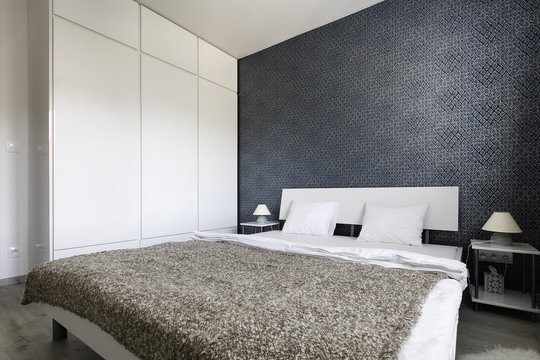 Bedroom with blue wallpaper