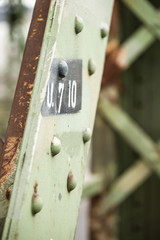 old rusty iron bridge structure with notes for demolition