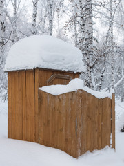 Public toilet covered with snow in the park