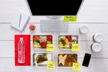 Healthy daily meals in office, top view at wood