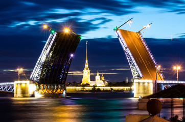 Fototapeta na wymiar Russia, Saint Petersburg Night view of Palace Bridge drawbridge, and the Peter and Paul Fortress