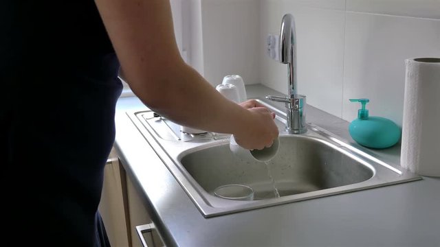 High quality video of washing dishes by a woman in 4K. Footage created on an professional electronic slider