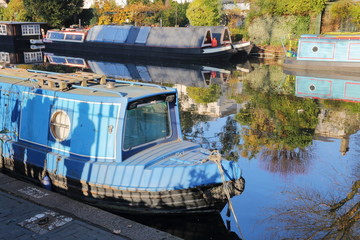 Fototapeta premium LONDON, UK: Reflections in Little Venice with colorful barges along canals
