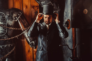 Obraz na płótnie Canvas Side portrait of Victorian gentleman adjusting his top hat.