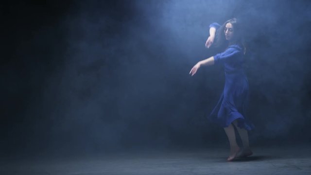 Young Woman Doing Jumps in Artificial Fog