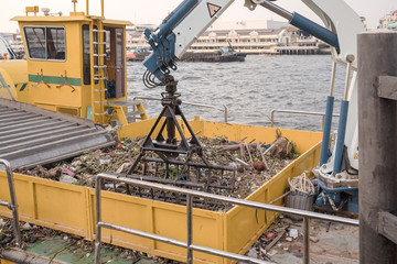 Weeding machine / View of weeding machine in the boat on the river.