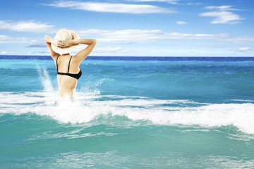 waves on sea and woman in bikini 