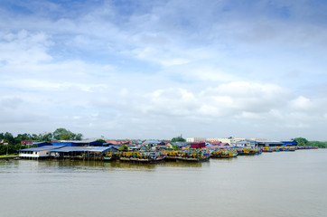 Naklejka premium JOHOR, MALAYSIA - JANUARY 30, 2017: Fishing boats anchored at the jetty during the monsoon season at Endau, Johor, Malaysia. Endau is one of the most important fisheries in Johor.