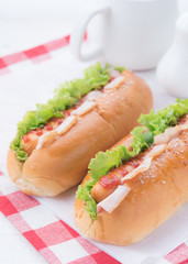 fast food,hot dogs with various ingredients on wood background