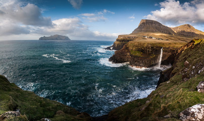 Fototapeta na wymiar Waterfall above the sea near Gasadalur village, Faroes Islands