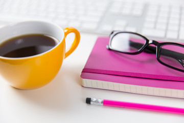 Coffee cup, glasses and computer keyboard