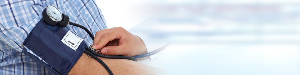 Doctor measuring patient blood pressure.