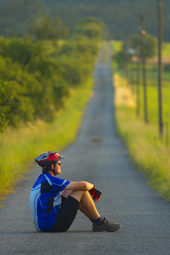 A cyclotourist sitting on the road