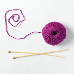 Colorful knitting yarn ball and knitting needles top view