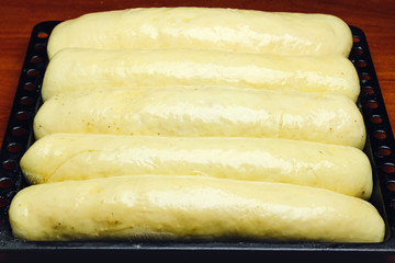 Process of making homemade pie, raw strudel on baking pan.