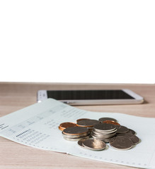Coins on book bank account for money saving concept and white bl