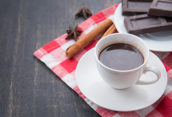 Hot Chocolate in white cups with Chocolate bar on the wooden table