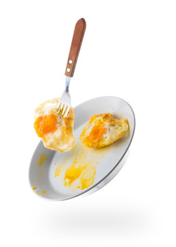 fried eggs with fork on white plate isolated white background,fl