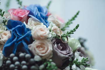 Wedding.Decor. Artwork.Rings of bride and groom on bouquet with