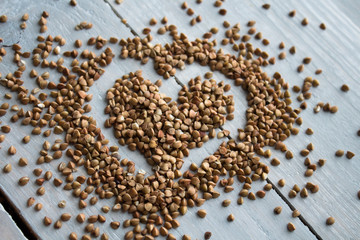 buckwheat porridge on wooden board heart-shaped