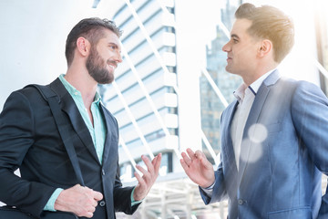 Fototapeta premium Two Westerner Business men talk and have good gesture on the pub