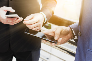 Two Westerner business man using smartphone