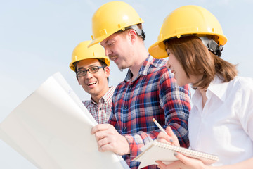 three construction engineers working outdoors in construction si