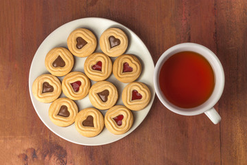 Cup of tea and heart-shaped cookies with copyspace