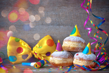 Carnival donuts with paper streamers and party bow tie