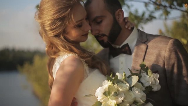Wedding couple in autumn park. The park has a lot of yellow leaves and gentle sentiments