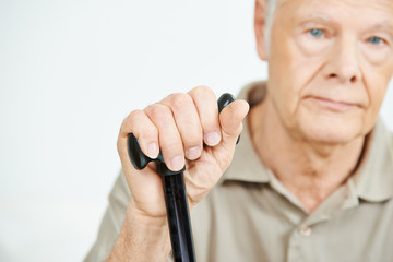 Hand of a senior man with a cane