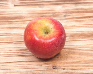 Ripe organic kanzi apple on vintage wooden tray