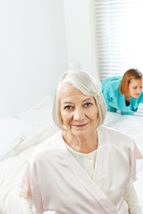 Obraz premium Senior woman with cleaning lady at home