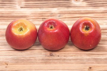 Ripe organic kanzi apple on vintage wooden tray