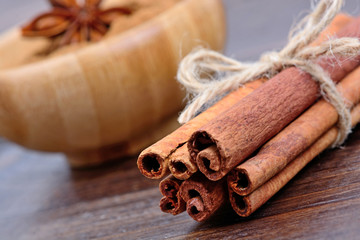 Rolling of cinnamon sticks and  powder in a bowl