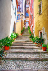Narrow european street with cobblestone steps and old houses, Portugal