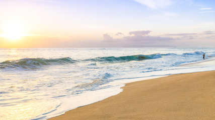 Man fishing and enjoying an amazing sunset in Polihale beach, Kauai island, Hawaii