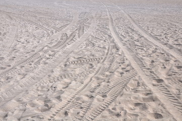 Footprints and tracks in the sand on the beach