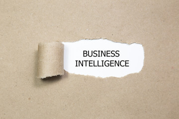 business intelligence written under torn paper